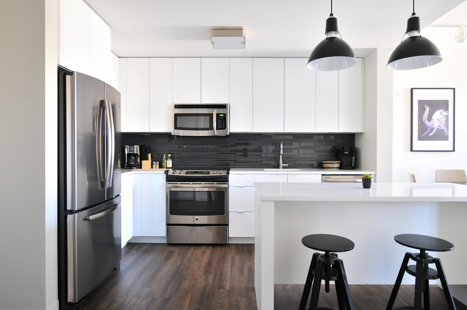 Modern kitchen remodel with white cabinets and quartz countertops by EZ Renovations in Waldorf MD